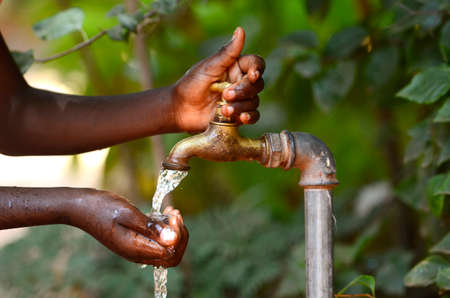 69928715 drinking water from a tap water scarsity symbol